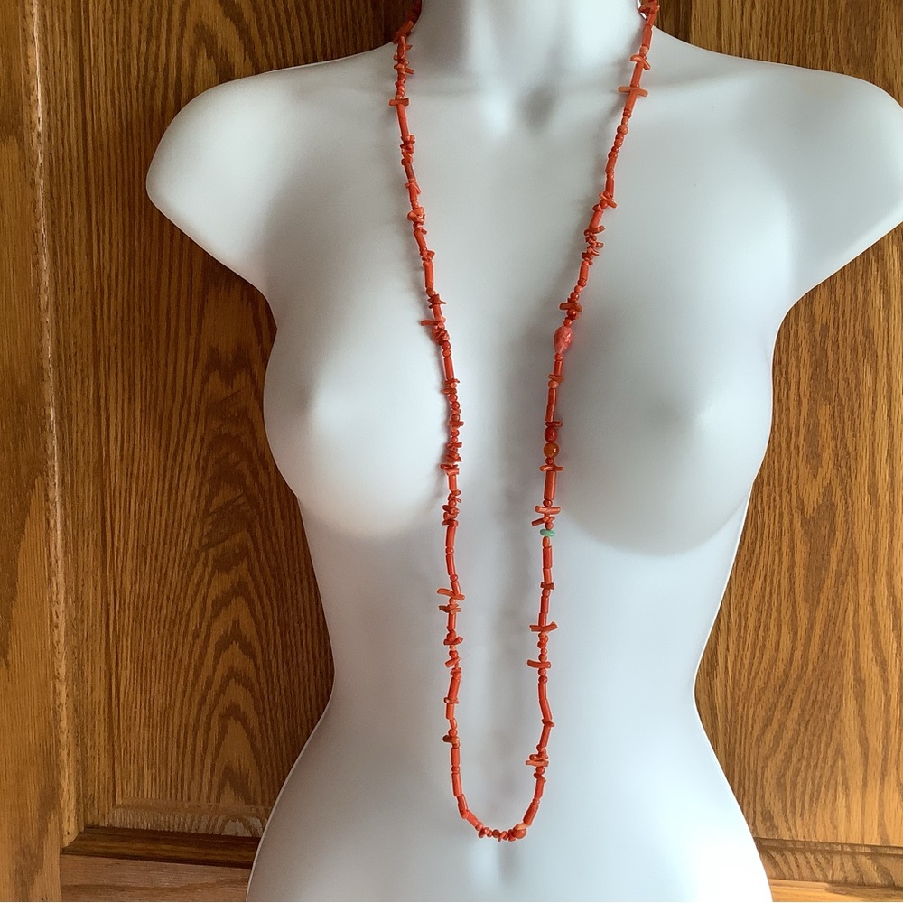 Coral ? Stone? And one turquoise colored bead. Long necklace